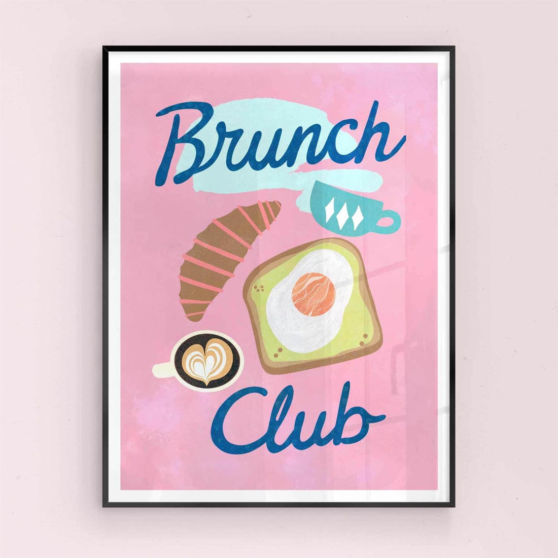 Framed artwork with 'Brunch Club' text and breakfast items on a pink background with black frame