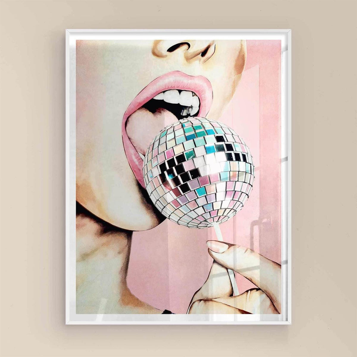 Framed artwork of a person's mouth holding a disco ball against a pink background with white frame.