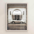 Framed photo of a classic car in front of a Cartier store entrance on natural/oak frame
