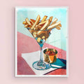 Fries in a martini glass with a small candle on a colorful background