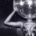 Person holding a disco ball with a black and white filter
