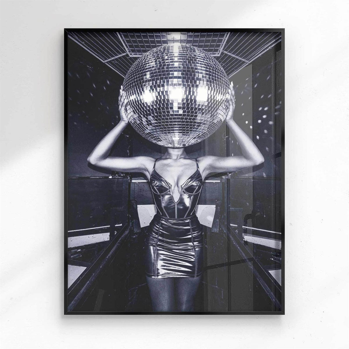 Person wearing a reflective outfit with a disco ball on a white background - black frame