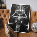 Poster of a person with a disco ball for a head on a brown sofa with leopard print pillows - white frame