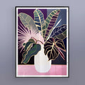 Framed artwork of a vase with colorful leaves on a gray wall