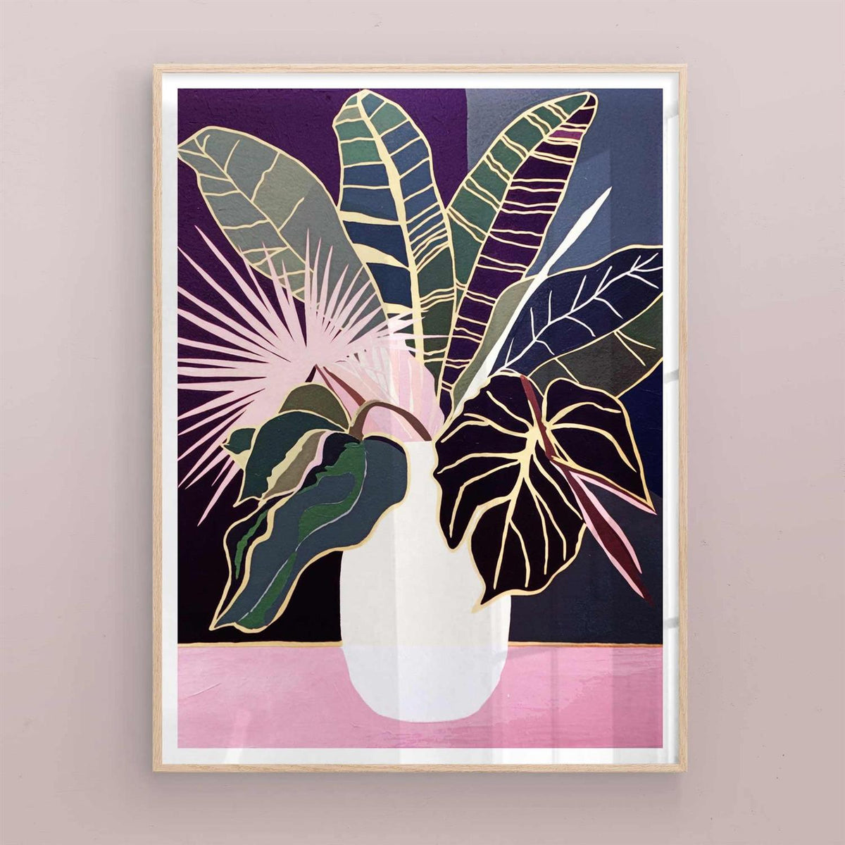 Framed artwork of a vase with tropical leaves on a purple background with natural/oak frame