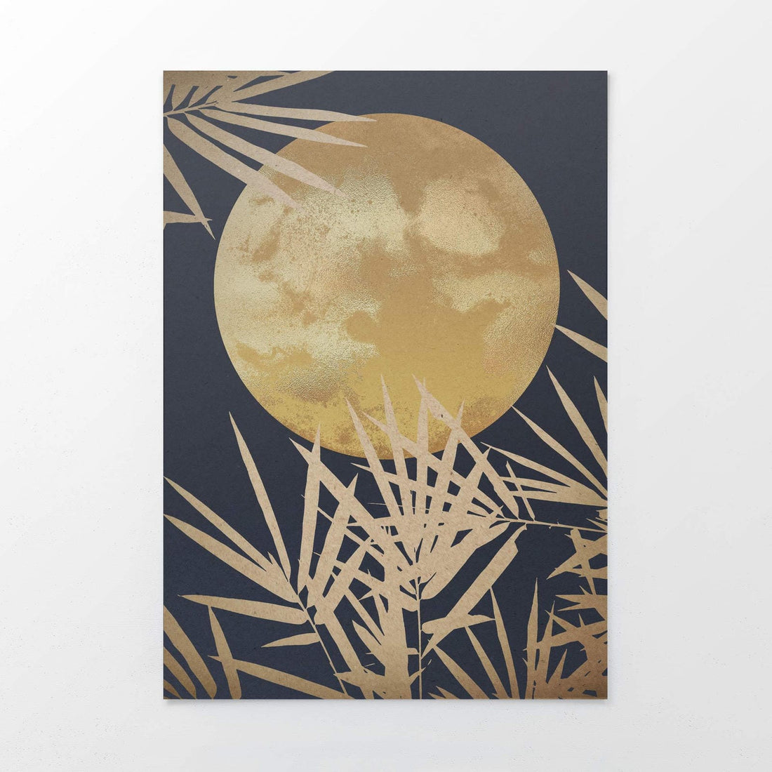 Framed artwork with a gold moon and leaf design on a dark background