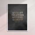 Framed artwork with gold text 'LET'S GET TOGETHER AND FEEL ALRIGHT' on a dark background - white frame