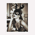 Woman wearing a black leather mask with bunny ears indoors.