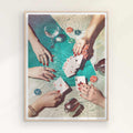 Framed artwork of hands playing cards with drinks and chips on a table on a oak/natural frame