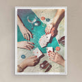 Framed artwork of hands playing cards with drinks and chips on a table on white frame