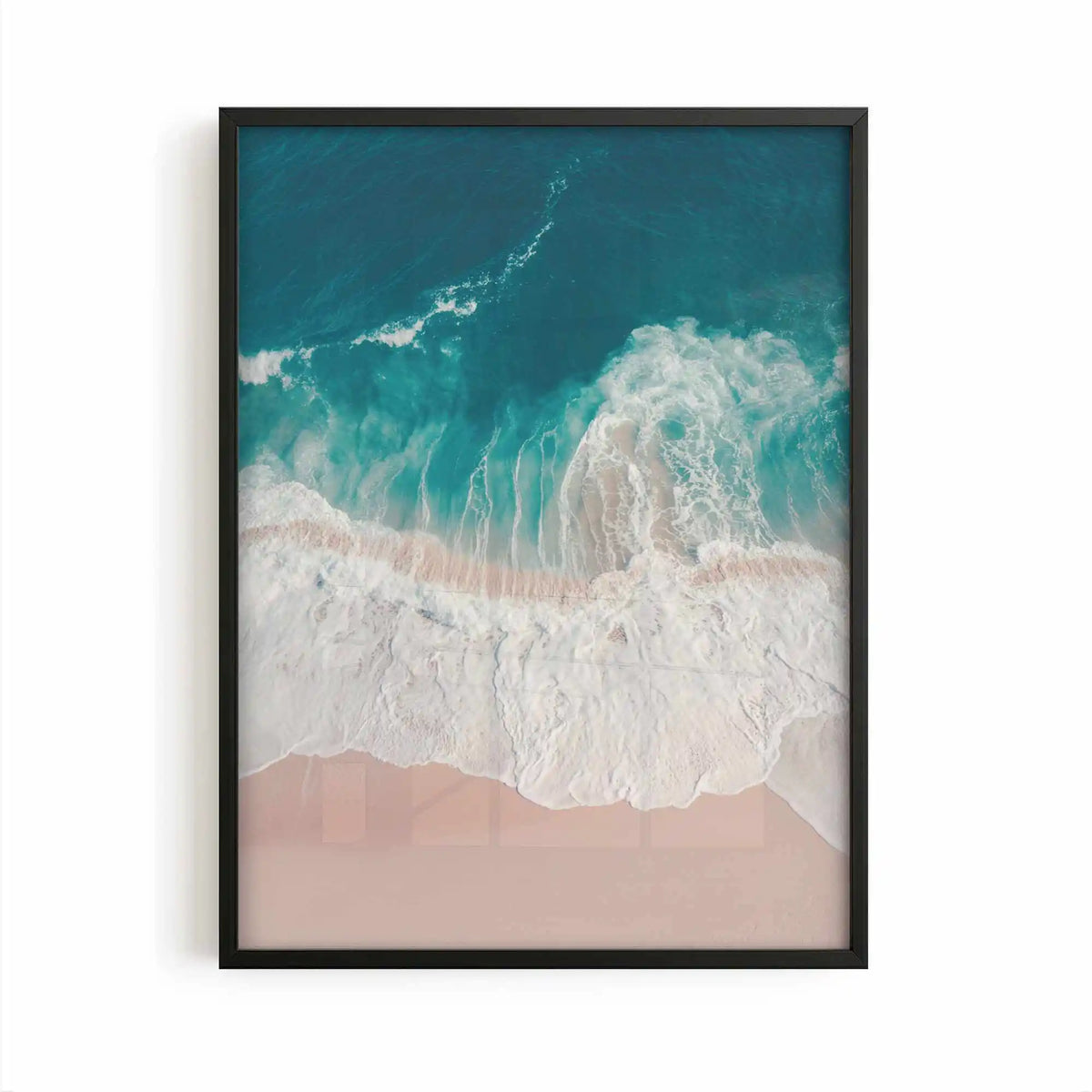 Aerial beach photography print showing turquoise ocean waves washing onto soft sandy shores in a calming coastal scene.