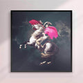 Framed artwork of a person riding a rearing horse with pink accents on a dark background - black frame