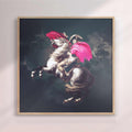 Framed artwork of a rearing horse with a person on it against a dark background - oak/natural frame