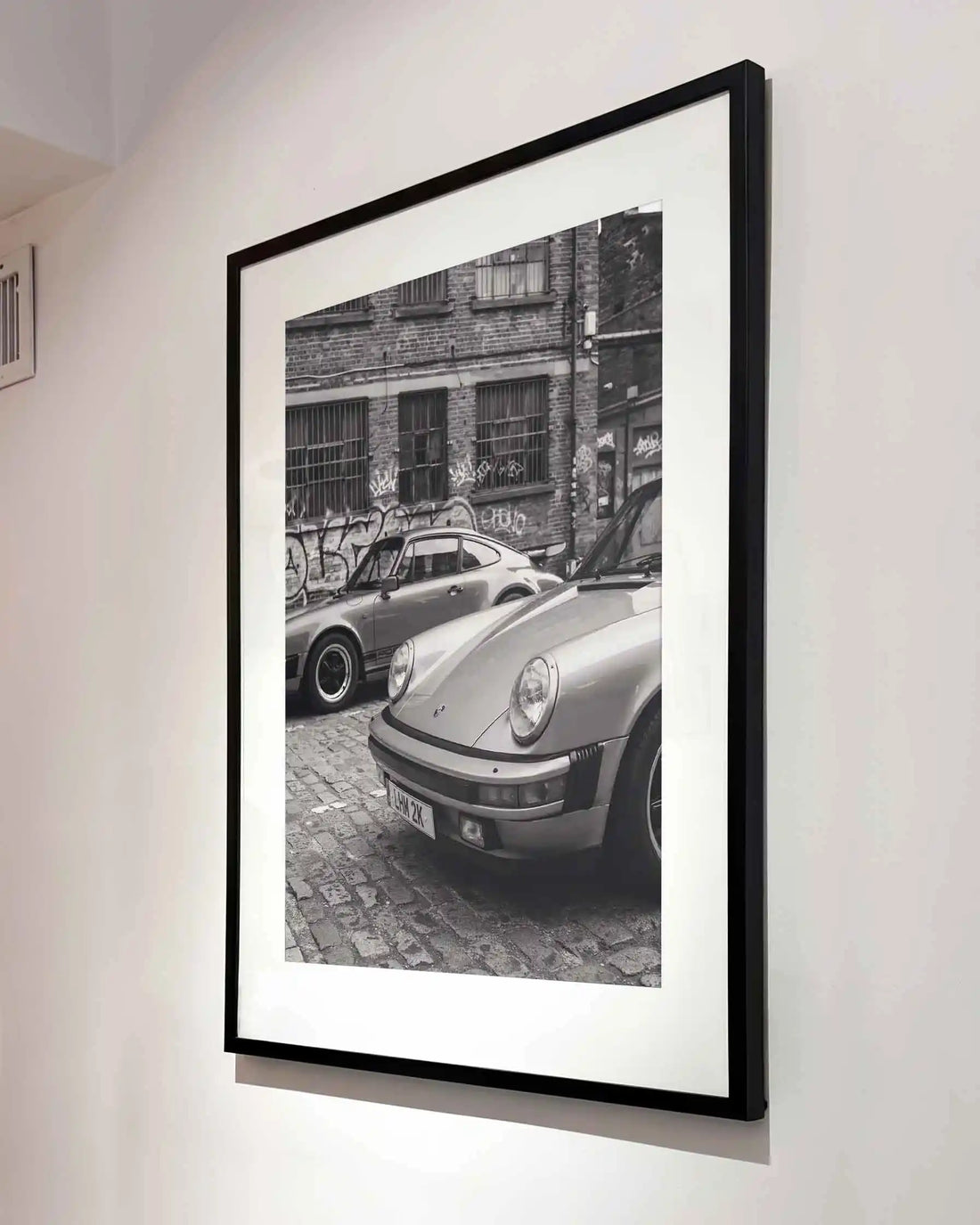 Nine Eleven Porsche 911 black and white photography print displayed in a contemporary black frame.