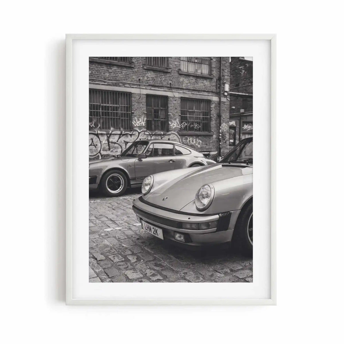Nine Eleven monochrome Porsche wall art displayed in a white gallery frame.